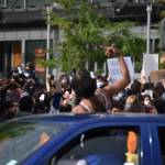 A woman cheers on Bellevue protesters from her car as it drives by, Sunday, May 31. Photo by Haley Ausbun.