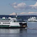 Ferries pass on a crossing between Mukilteo and Whidbey Island. (Andy Bronson / Herald file)
