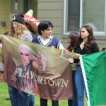 Directly across the street from a crowd holding pro-Trump and anti-Biden signs, members in this crowd hold flags representing the nations of Peru, Flavortown and Mexico, as well as a miniature rainbow pride flag. Photo by Alex Bruell/Sound Publishing
