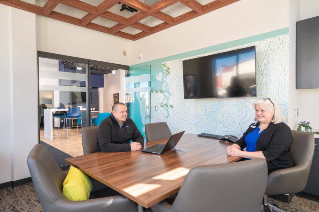 Chris Neros meeting with Jennifer Barnhart, Universal Banker in the Fairhaven branch. Photo credit: Nakean Wickliff
