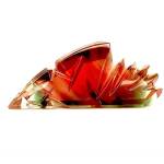 Award-winning lapidary artist Daryl Alexander teasingly threatened licked the rough Oregon Sunstone gem (left) to stake his claim. He cut two extraordinary gems (centre, right).