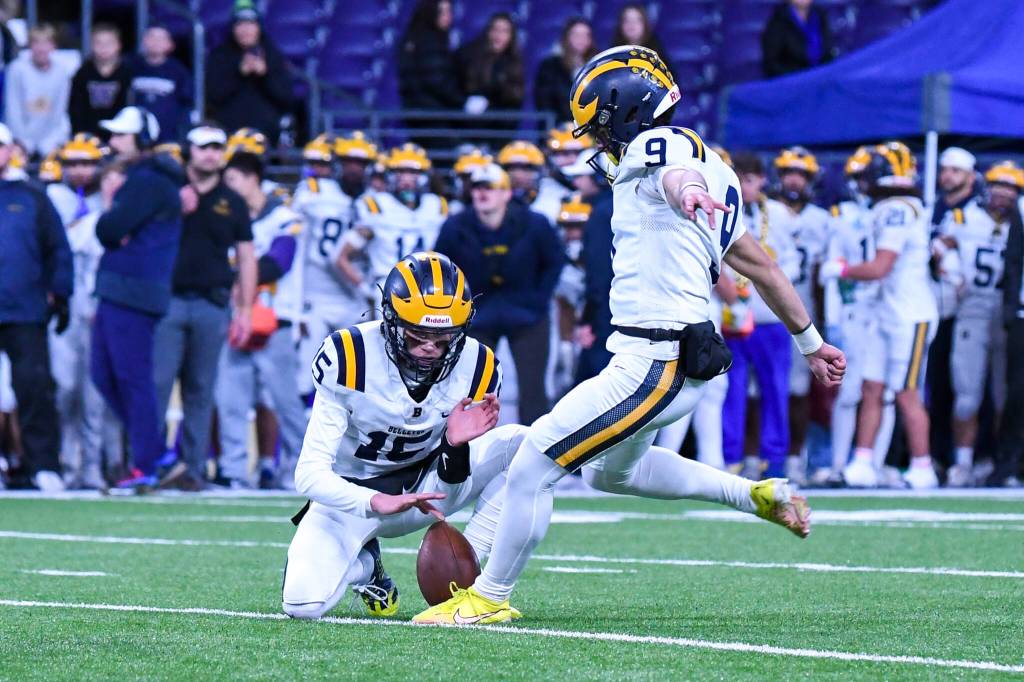 Bellevues Luke Scoma kicks the extra point after the Wolverines second touchdown off a hold by Bellevue quarterback Lucas Razore. Photo courtesy of Stephanie Ault Justus