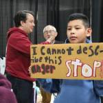 Community members make signs at the Tsuru for Solidarity station.